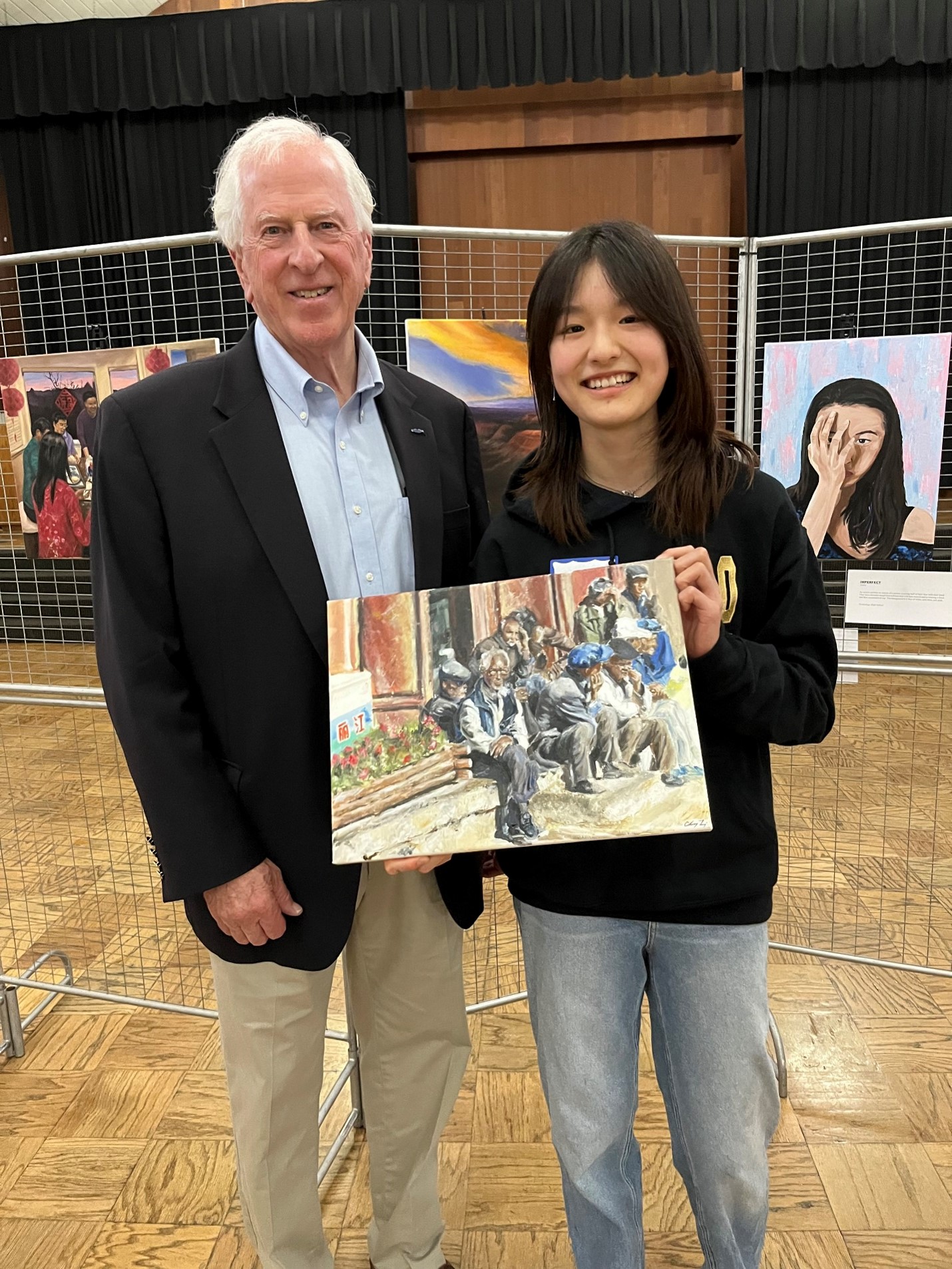 Rep. Thompson standing with Catherine Li who is holding her artwork.