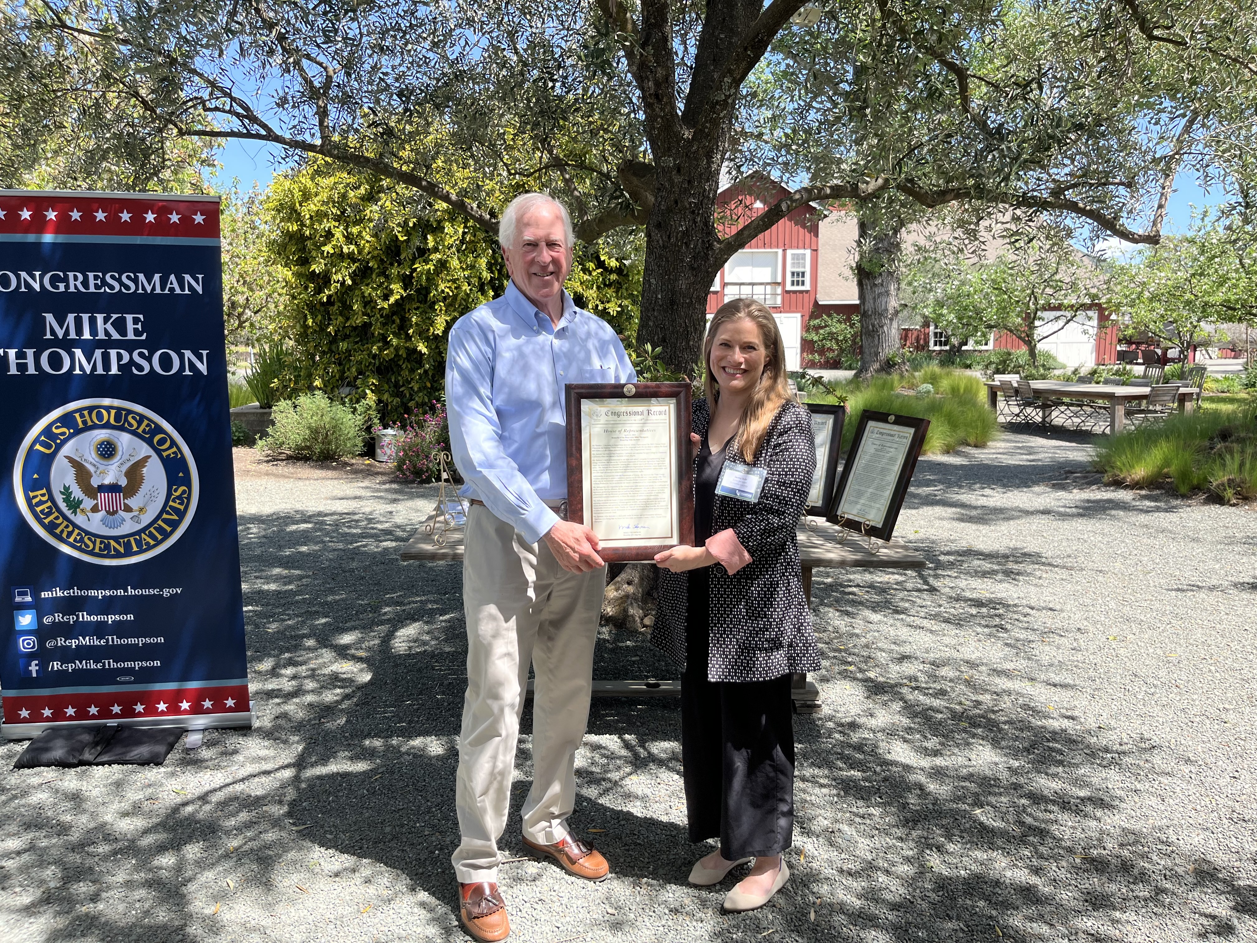 Rep. Thompson presents the award to Jenny Juhl, accepting the award on Julia Jackson's behalf